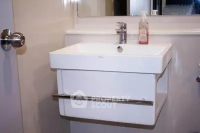 Modern bathroom with sleek white sink and chrome fixtures
