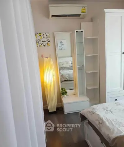 Charming bedroom with modern decor, featuring a cozy bed, elegant lighting, and sleek storage solutions.