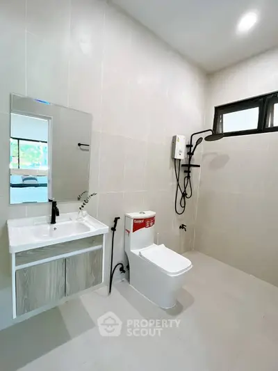 Modern bathroom with sleek fixtures and spacious layout in a contemporary home.