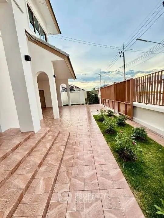 Elegant exterior with tiled walkway and lush garden in modern home