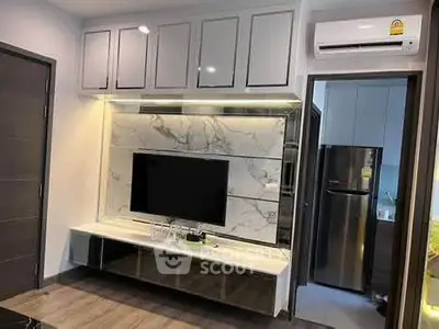 Modern living room with sleek TV unit and stylish kitchen view