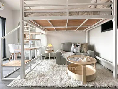 Modern loft-style living room with cozy seating and workspace