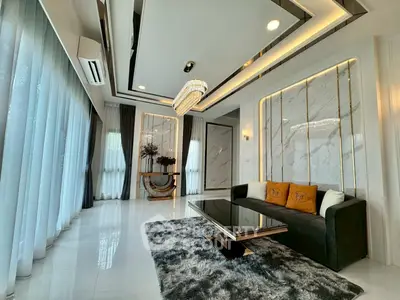 Luxurious living room with modern chandelier and elegant decor