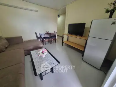 Cozy living room with modern furniture and dining area, perfect for small gatherings.