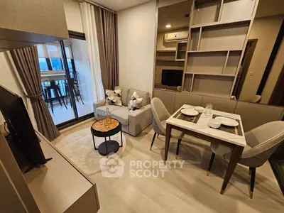 Modern living room with open balcony and stylish dining area in a cozy apartment.