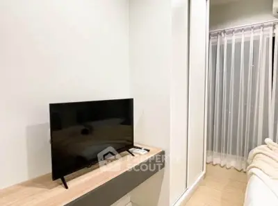 Modern bedroom with sleek TV setup and cozy ambiance