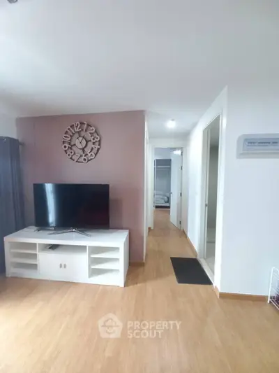 Modern living room with stylish wall clock and TV setup