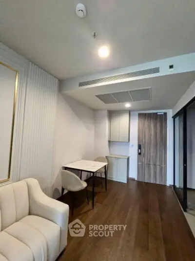 Modern living room with elegant furniture and wooden flooring in a stylish apartment.