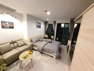 Modern studio apartment with cozy living area and city view.