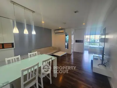Modern living room with sleek dining area and stylish lighting