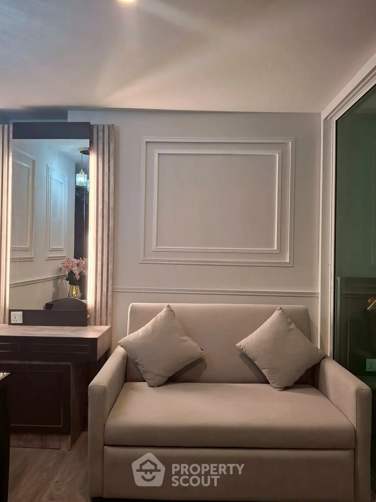 Elegant living room with stylish sofa and decorative wall paneling, perfect for modern urban living.