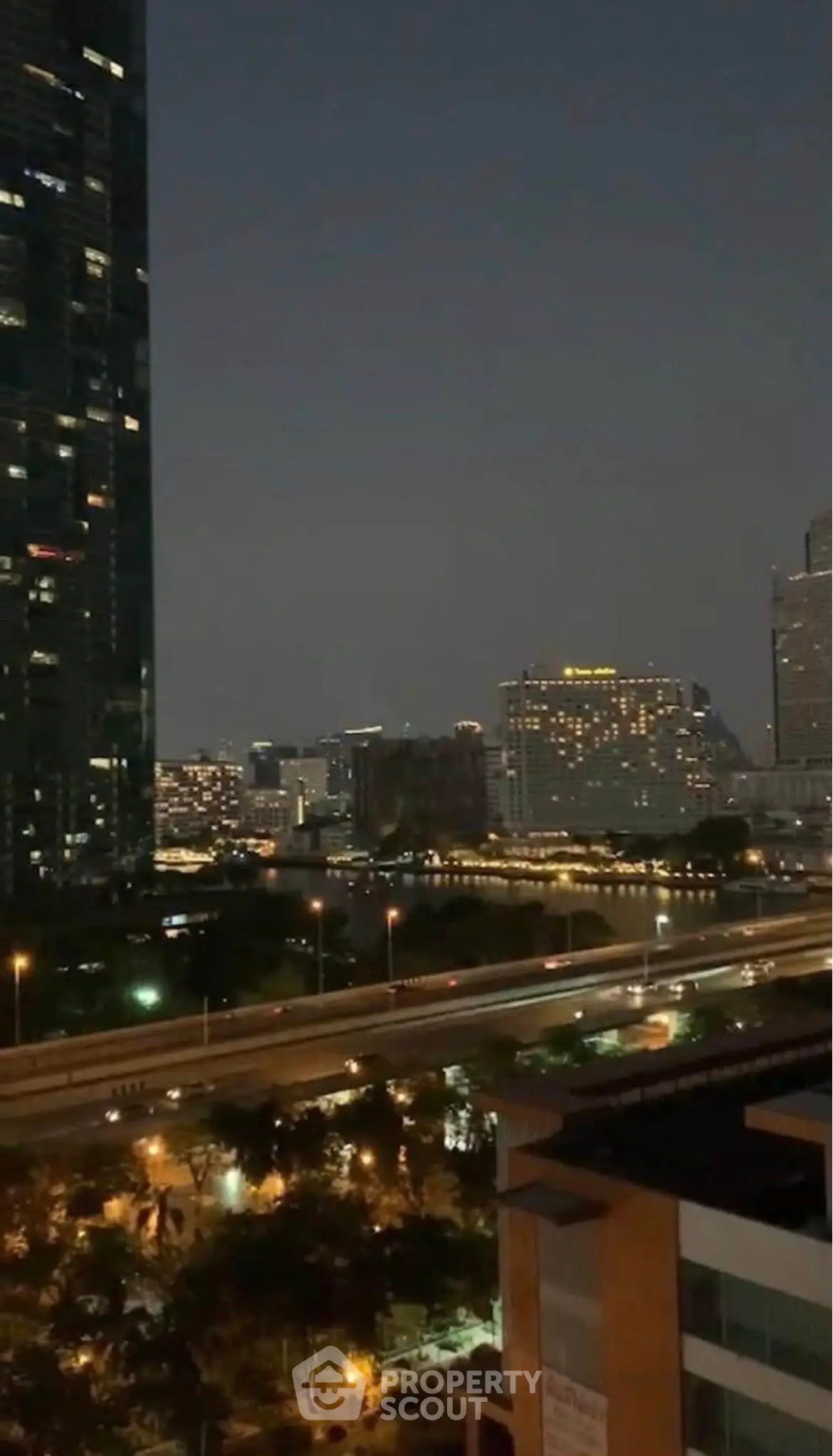 Stunning cityscape view from high-rise building at night with illuminated skyline.