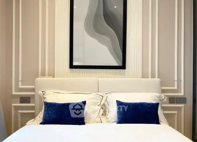 Elegant bedroom with modern decor and plush pillows in a stylish setting.