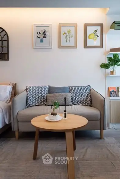 Chic living room with cozy sofa, stylish decor, and elegant wall art in modern apartment.