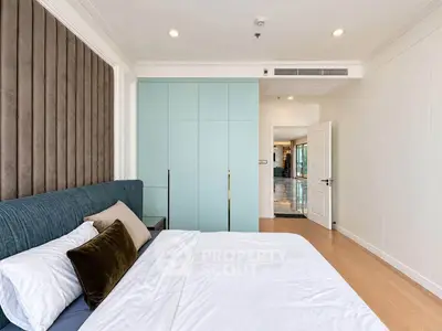 Spacious modern bedroom with elegant decor and ample natural light