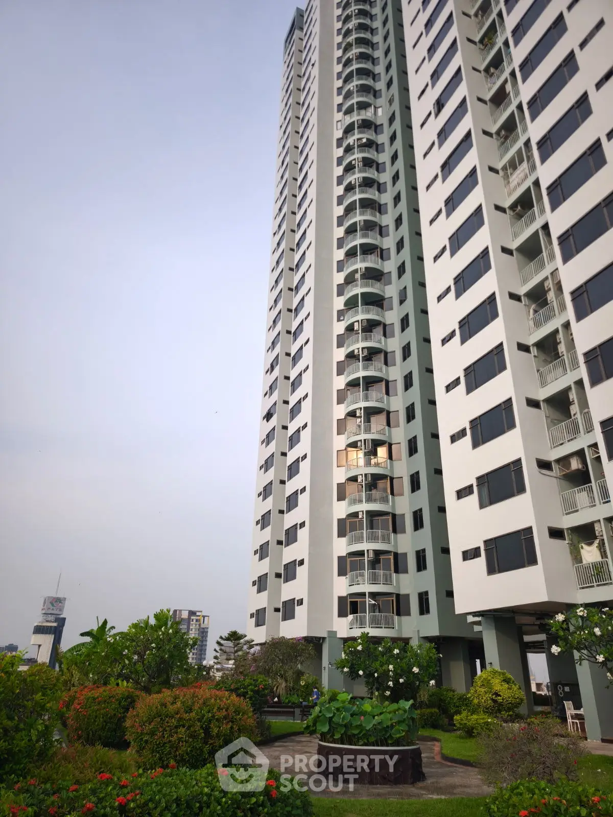 Stunning high-rise building with lush garden, perfect for urban living.