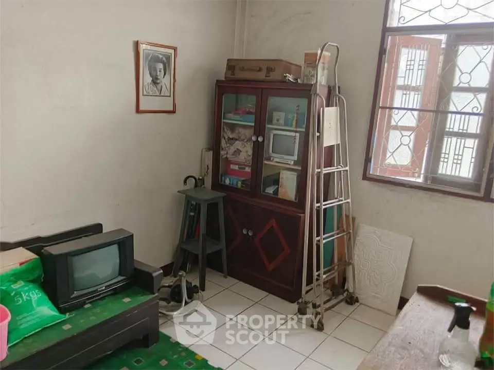 Cozy vintage living room with retro TV and cabinet, perfect for nostalgic charm seekers.
