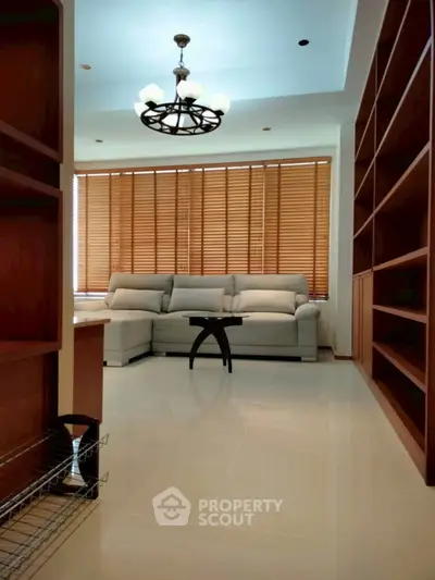 Spacious living room with modern sofa and elegant wooden shelves