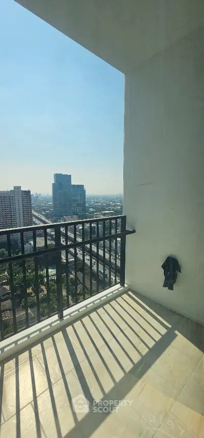 Spacious balcony with stunning city view in modern high-rise apartment