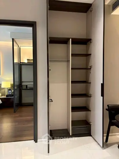 Modern open closet with shelving and hanging space in a stylish bedroom
