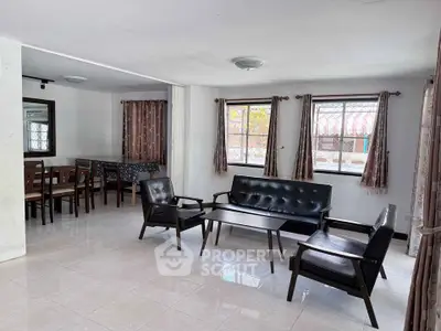 Spacious living room with modern furniture and large windows for natural light.