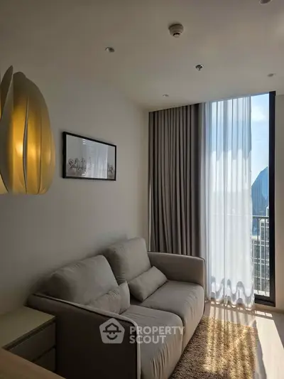 Cozy living room with modern sofa and large window offering city view