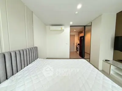 Modern bedroom with sleek design and air conditioning in a stylish apartment.