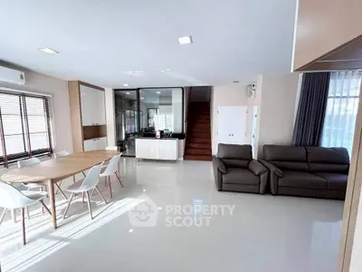 Spacious modern living room with dining area and sleek furniture