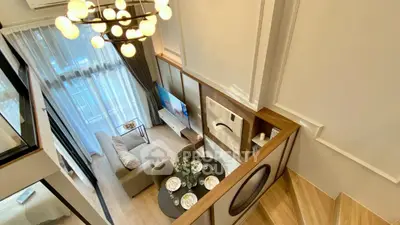 Luxurious modern living room with high ceiling and elegant chandelier in a stylish apartment.