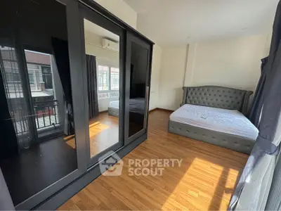 Spacious bedroom with modern design and large windows for natural light.