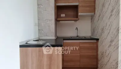Compact kitchen with wooden cabinets and modern design
