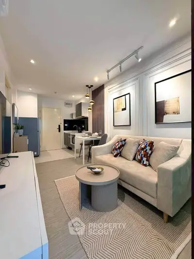 Modern living room with stylish decor and open kitchen layout in a cozy apartment.