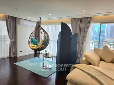 Luxurious living room with hanging chair and city view, perfect for relaxation and comfort.