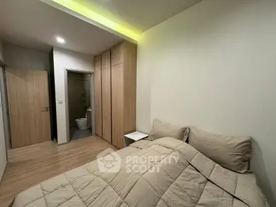 Cozy bedroom with modern design and ensuite bathroom in a stylish apartment.