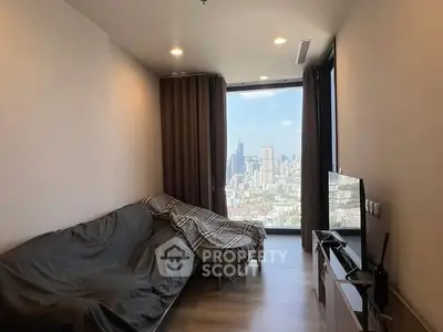 Modern living room with panoramic city view and cozy furnishings.