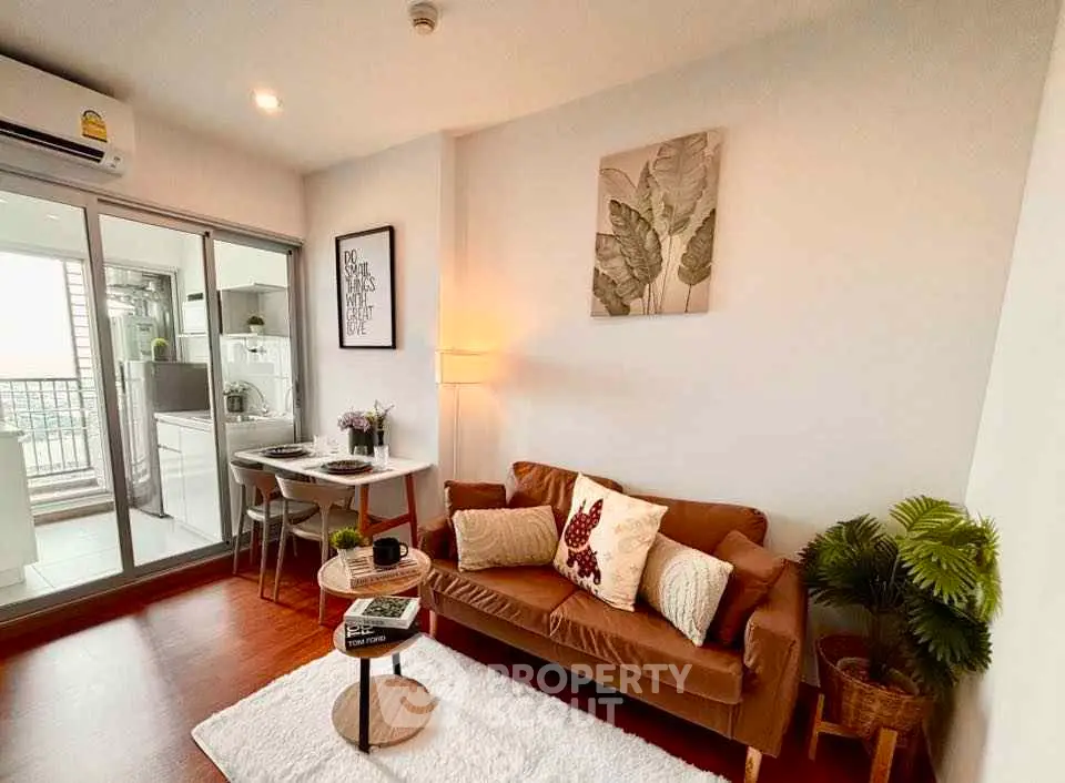 Cozy living room with modern decor and balcony access in stylish apartment.