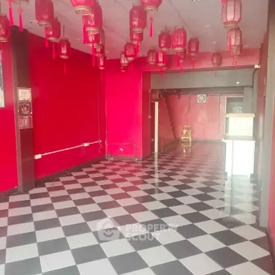 Vibrant commercial space with checkered flooring and red lanterns, ideal for a unique business setup.