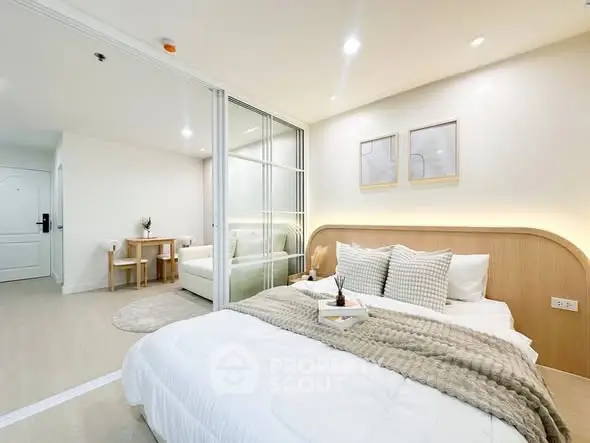 Modern bedroom with cozy decor and open layout in a stylish apartment.