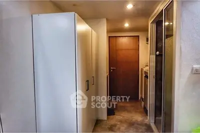 Compact hallway with modern storage and access to bathroom and kitchen