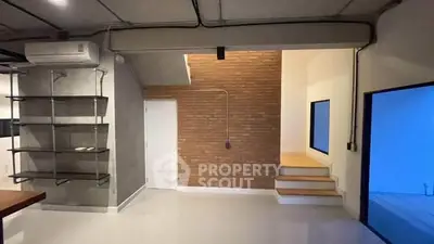 Modern industrial-style interior with exposed brick and sleek shelving