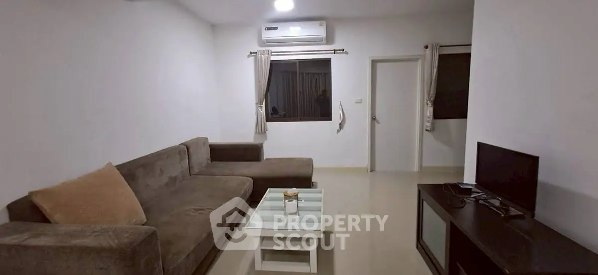 Modern living room with sleek furniture and air conditioning, perfect for comfortable living.