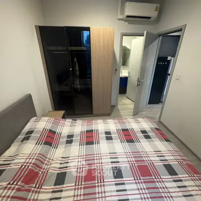 Cozy bedroom with modern wardrobe and air conditioning, perfect for comfortable living.