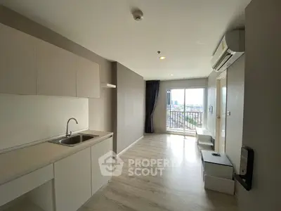 Modern apartment interior with open kitchen and balcony view