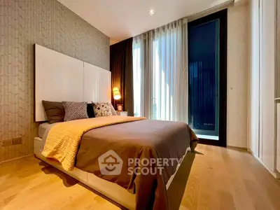 Luxurious bedroom with modern decor and floor-to-ceiling windows for natural light.