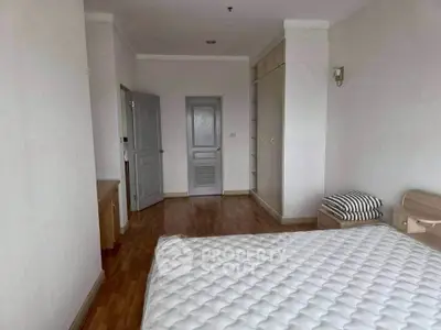 Spacious bedroom with wooden flooring and built-in wardrobe