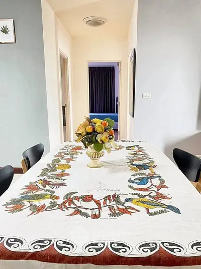 Charming dining area with elegant table setting and floral centerpiece, perfect for intimate gatherings.