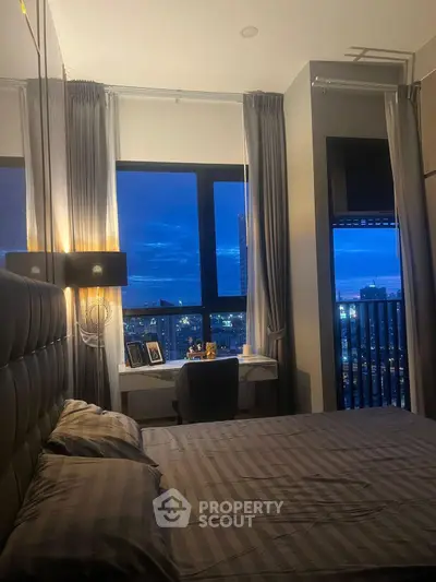 Luxurious bedroom with stunning city view and elegant decor, perfect for urban living.