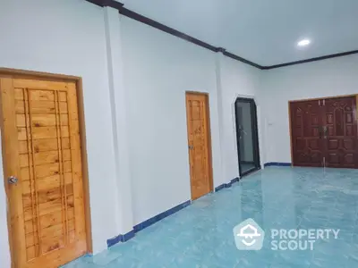 Spacious interior with wooden doors and blue tiled flooring