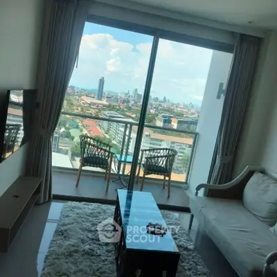 Modern living room with stunning city view from balcony, featuring cozy seating and stylish decor.