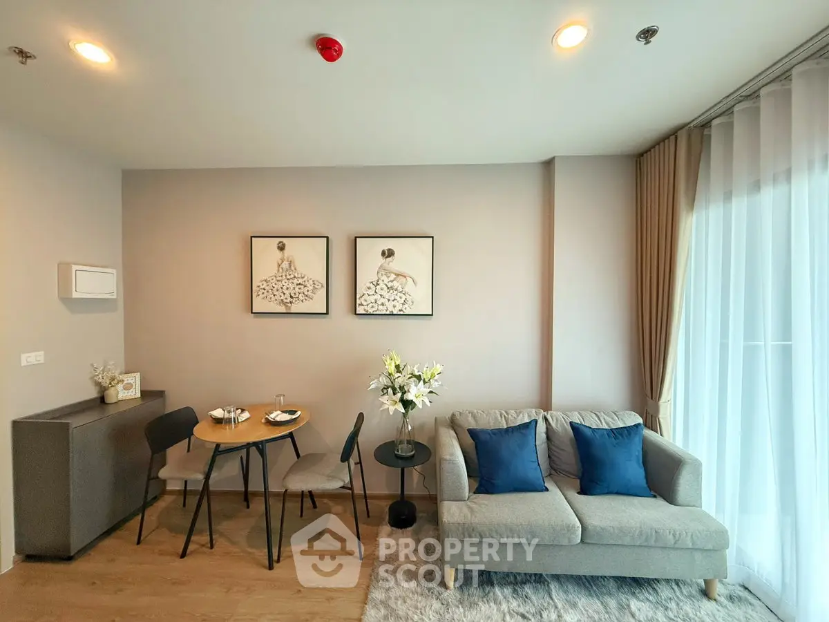 Stylish living room with modern decor, cozy sofa, and elegant dining area in a bright apartment.